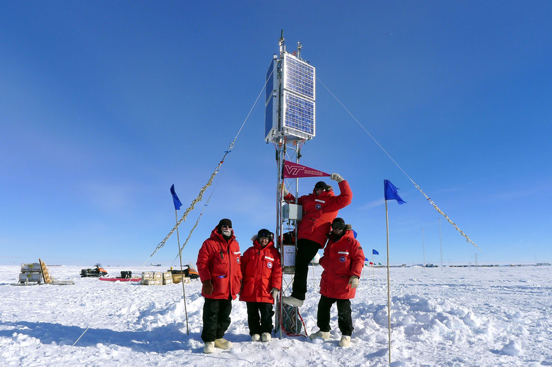 MIST members at South Pole Station raising the Virgina Tech flag.
